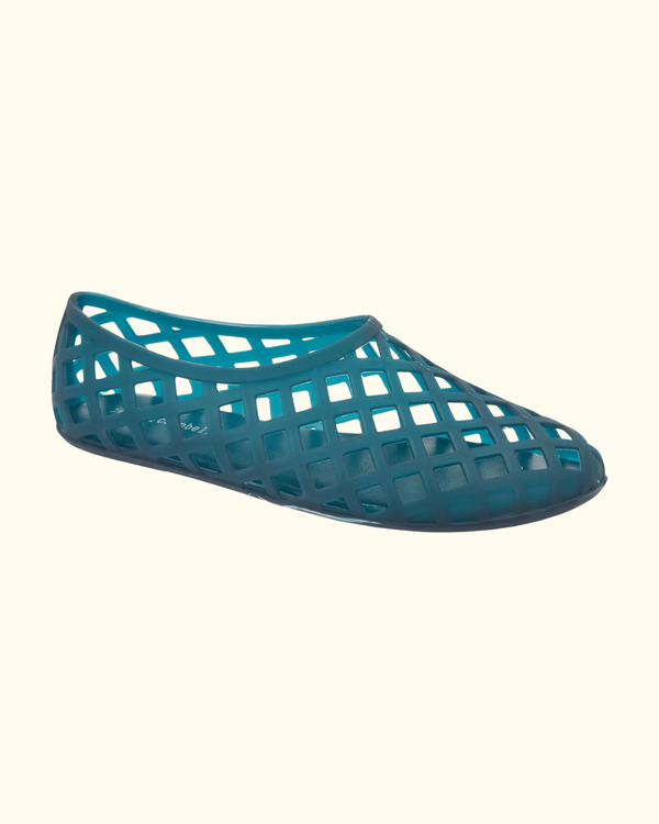 Teal matte perforated jelly flat shown from the outer side on a cream background.