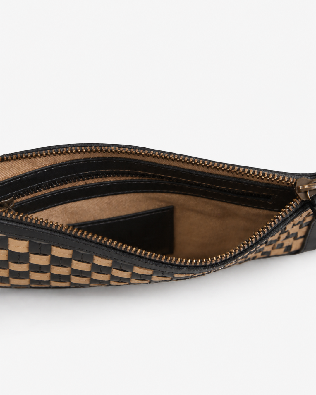 Interior detail of ABLE Nesmia Basketweave Clutch in Black Tan with zipper closure and pocket