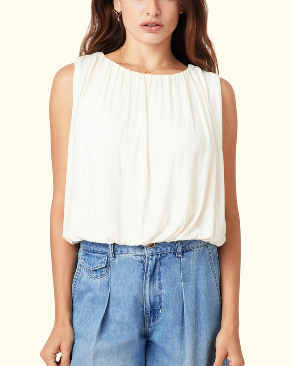 Model wearing Bubble Knit Top in Whisper White with gathered neckline and bubble hem