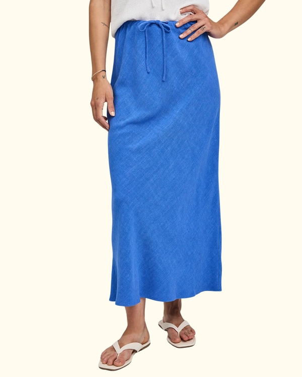 Model styling Cassia Skirt in Riviera as a warm-weather maxi skirt outfit