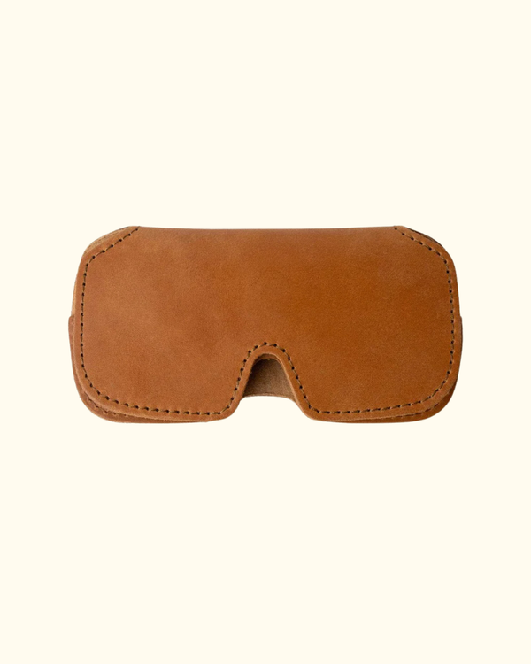 Closed tan full-grain leather sunglasses case with stitched edges