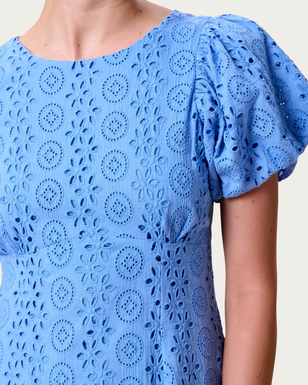 Close up of Leslie Midi Dress Blue Bonnet eyelet fabric and puff sleeve