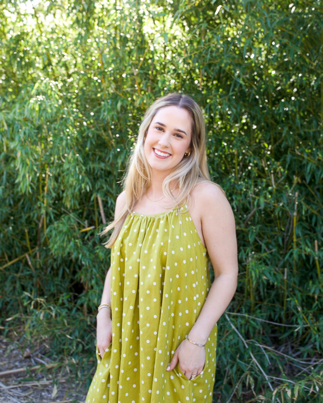 Moss green linen polka dot midi dress with gathered neckline and relaxed fit front view