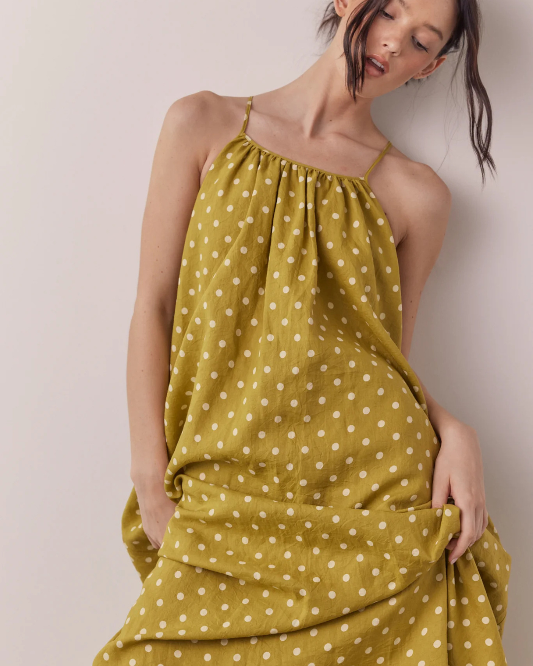 Close-up of Linen Polka Dot Tie Back Dress in Moss with white polka dot print