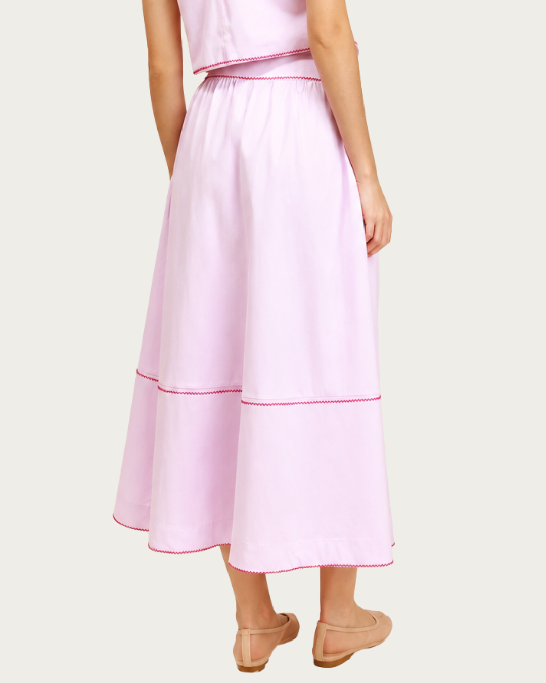 Back view of Lotus Skirt Pink with gathered waist and contrast stitching