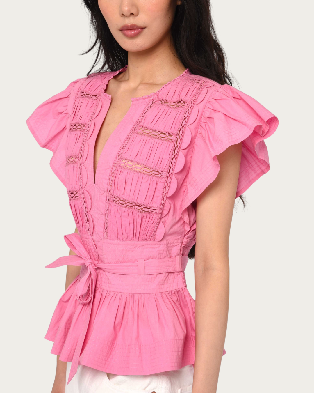 Close up of Madelyn Top Rosebloom with V-neckline and lace inset detail
