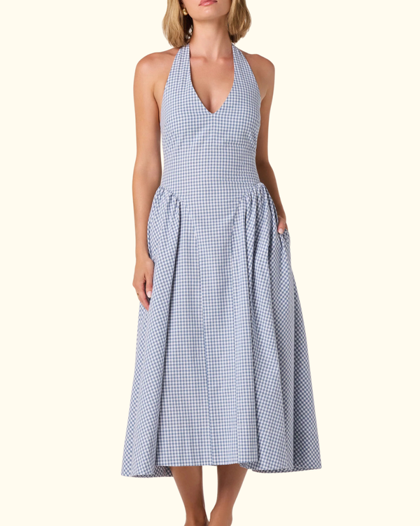 Model wearing Meana Dress in Blue Gingham with halter neckline and midi-length skirt