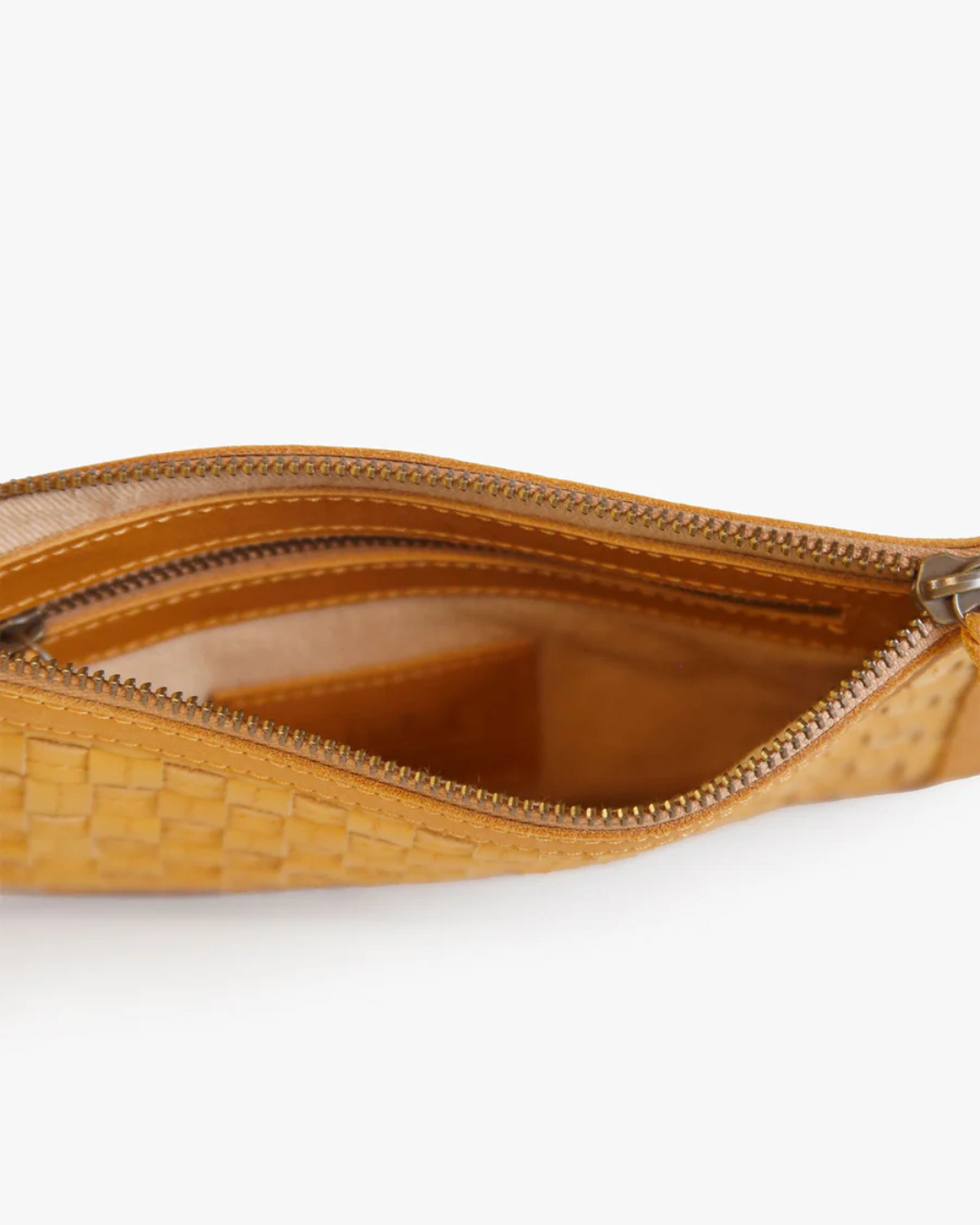 Interior detail of Nesmia Basketweave Clutch in Cognac with zipper closure and pocket