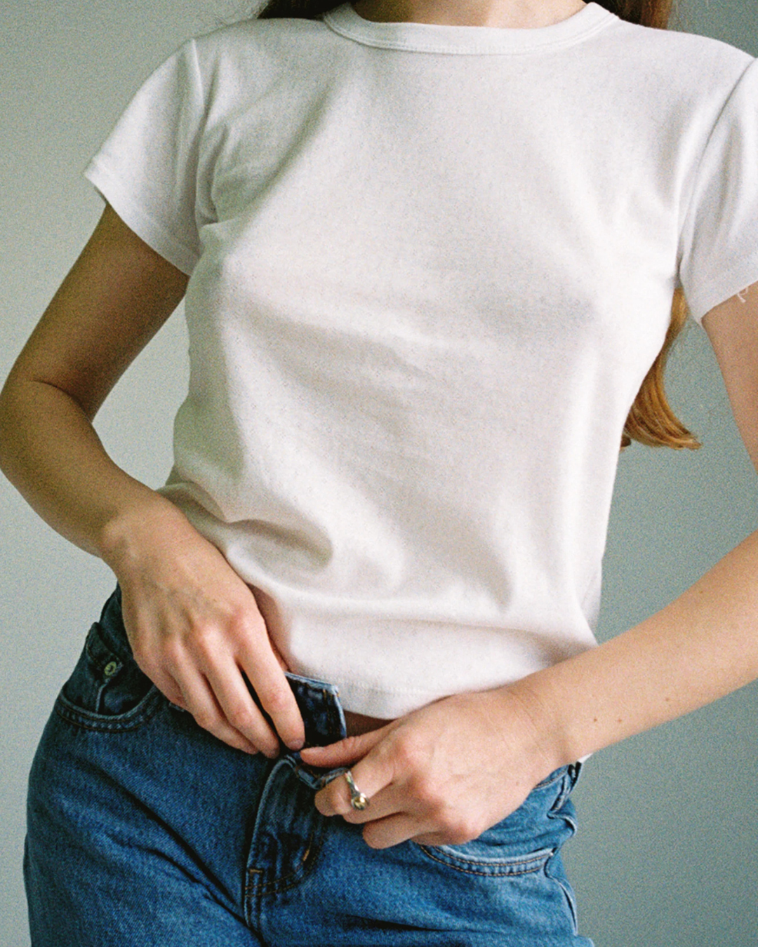 Model wearing Pointelle Baby Tee in White with denim