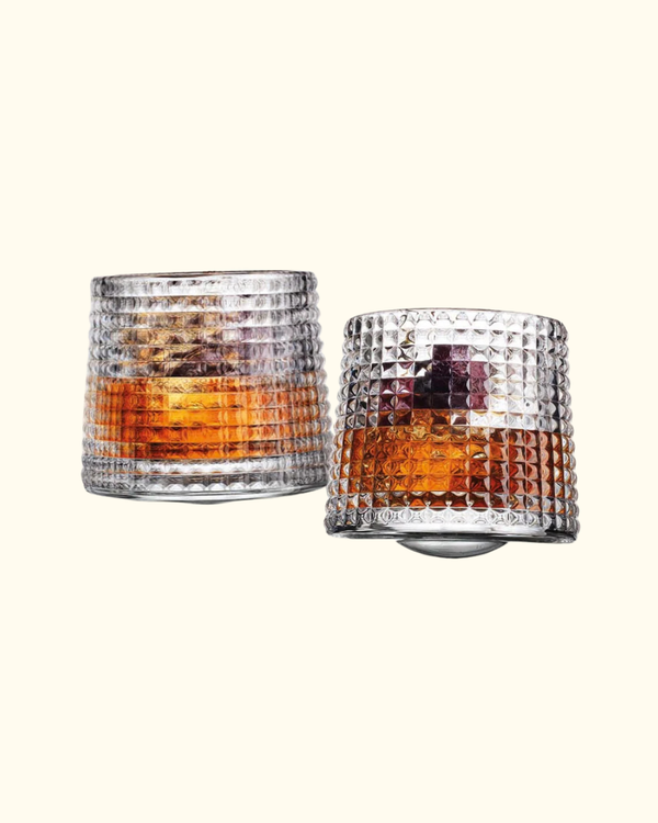 Revolve Spinning Whiskey Glass Set filled with whiskey showing textured crystal design