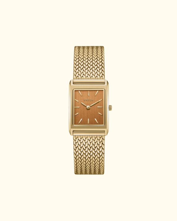 Gold rectangular watch with ochre dial and mesh band front view